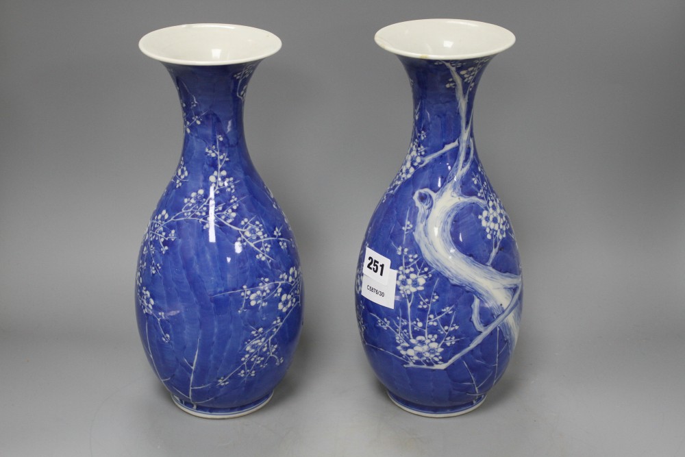 A pair of Japanese blue and white baluster vases, decorated with prunus trees, six character mark, height 31cm